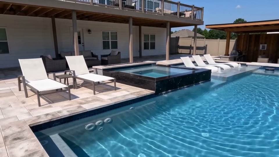 Todd & Vera's completed custom pool with an integrated spa and covered patio